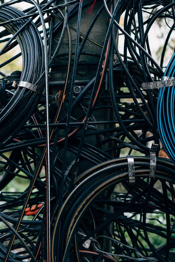 Mastering the First Impression: Your intriguing post title goes here A complex network of tangled electrical cables on a utility pole outdoors.