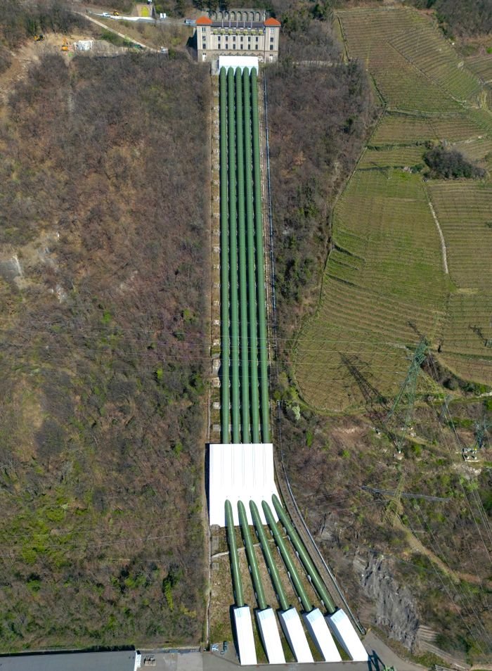 The Art of Drawing Readers In: Your attractive post title goes here Aerial shot of long green gas pipelines running through a forested area, highlighting industrial architecture.
